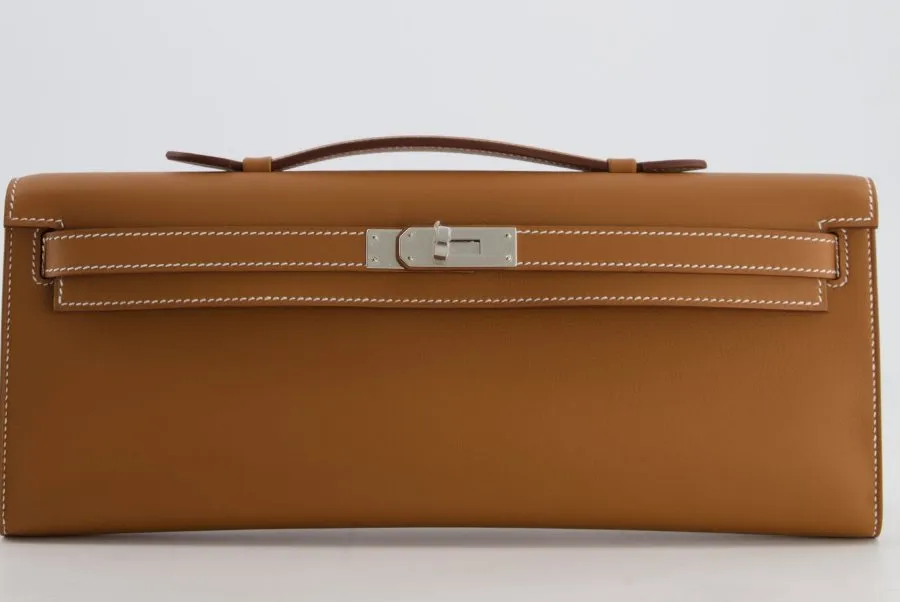 A Hermes Kelly Cut clutch in Gold Swift leather with palladium hardware